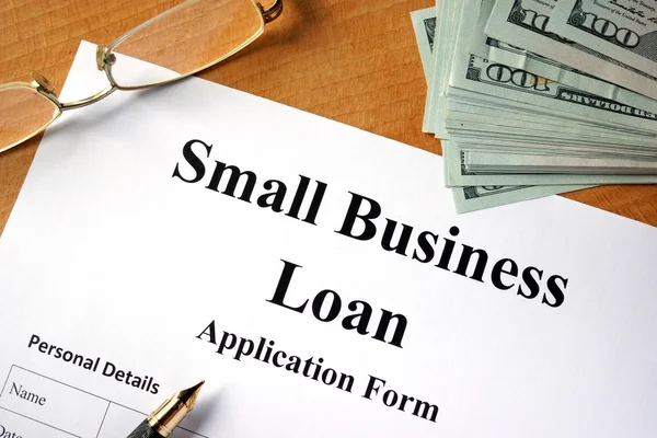 Small business loan form on a wooden table. — Stock Photo, Image