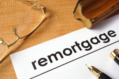 Page of paper with remortgage on a table. clipart