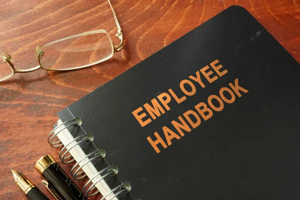 Employee handbook on a wooden table and glasses. — Stock Photo, Image