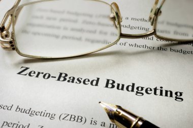 Sign Zero-Based Budgeting - ZBB on a paper and glasses. clipart