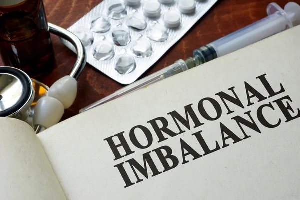 Book with words hormonal imbalance on a table. — Stock Photo, Image