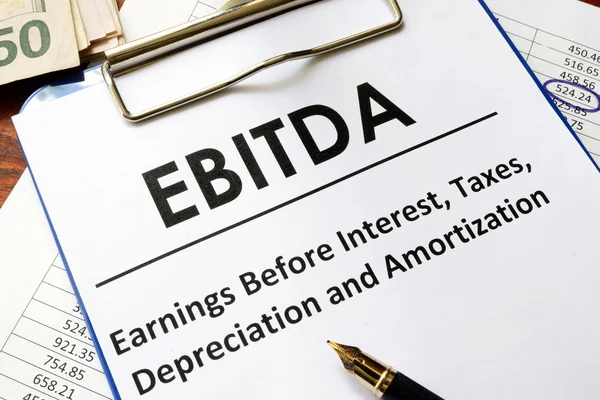 Paper with word ebitda  on a wooden surface. — Stock Photo, Image