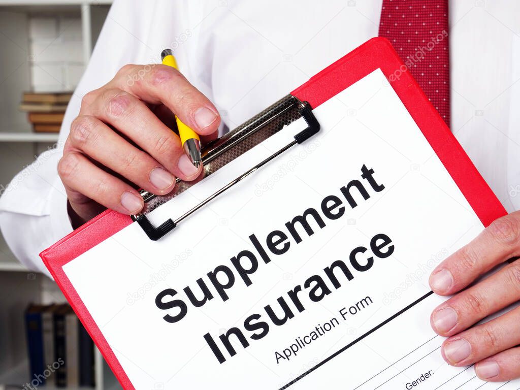 Supplement insurance form and insurer with pen.