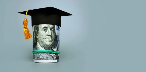 Loan or savings for college. Graduation cap and roll of cash. — Stock Photo, Image