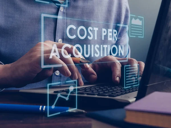 Cost Per Acquisition CPA concept. The marketer is working on a laptop.