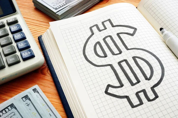 Dollar mark in the notepad and calculator. Savings and wealth concept. — Stock Photo, Image