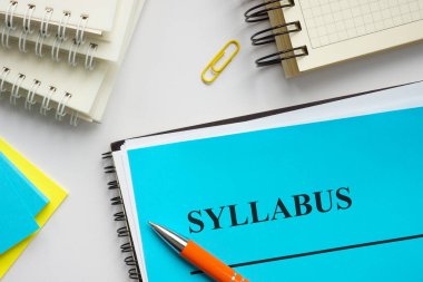 Syllabus educational plan and papers on the desk. clipart