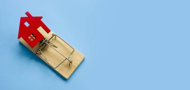 Mülk dolandırıcılığı ve tuzak konsepti. Ev ve fare kapanı modeli.