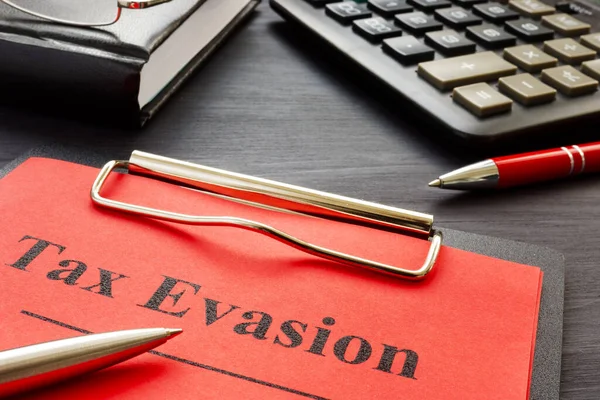 Tax evasion result of audit with clipboard.