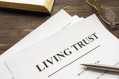 Living trust papers with pen and book. clipart