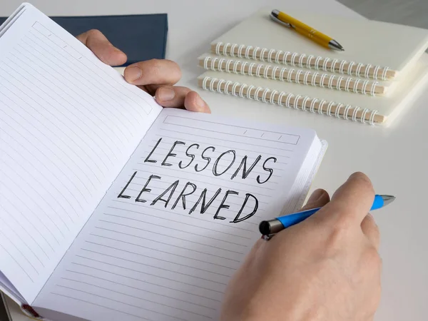 Lessons learned concept. The man made a diary entry. — Stock Photo, Image