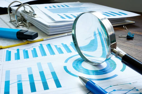 Internal audit with magnifier and financial figures and report. — Stock Photo, Image