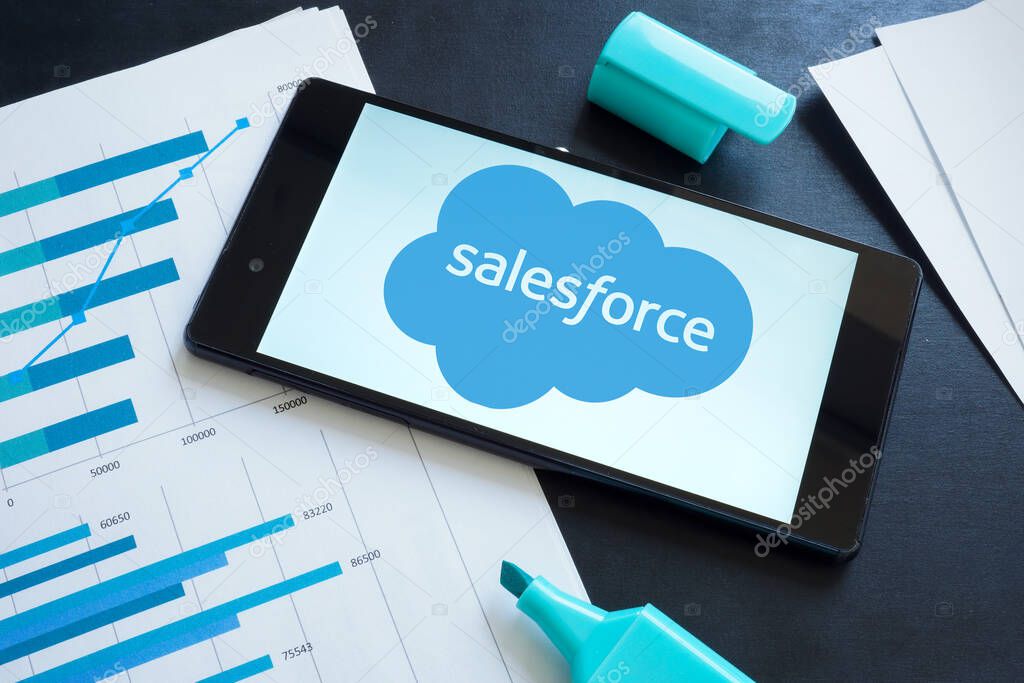 KYIV, UKRAINE - June 30, 2021. Salesforce logo on the smartphone and papers.