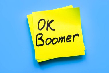 OK boomer words on the yellow piece of paper. clipart