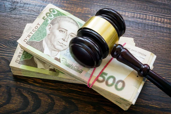 Ukrainian hryvnia money and a gavel. Bribery and corruption in court. — Zdjęcie stockowe