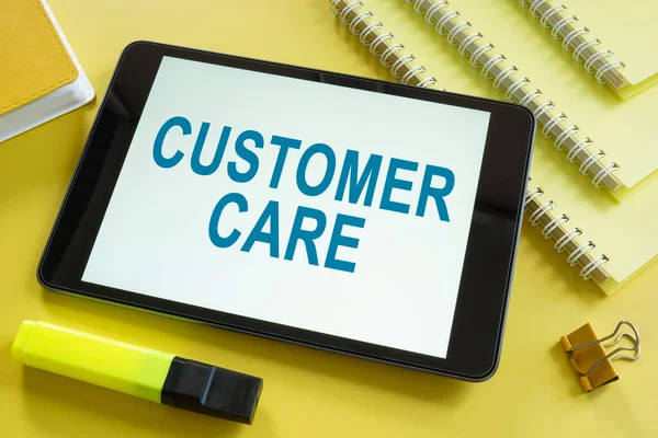 Customer care on the screen and notepads. — Stock Photo, Image