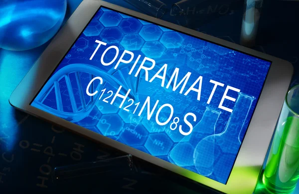 The chemical formula of  Topiramate on a tablet with test tubes — Stock Photo, Image
