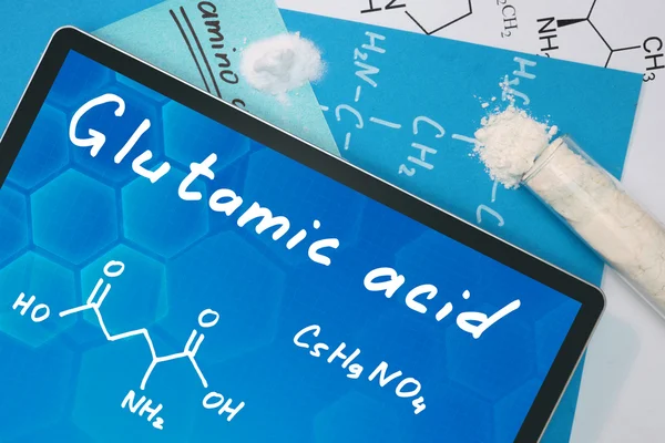 Comprimido con la fórmula química del ácido glutámico . —  Fotos de Stock