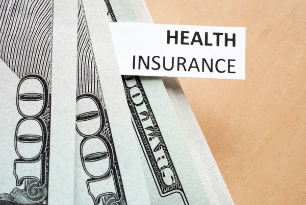 Paper with words Health insurance and money. — Stock Photo, Image