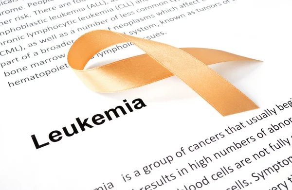 Paper with leukemia and orange ribbon. — Stock Photo, Image