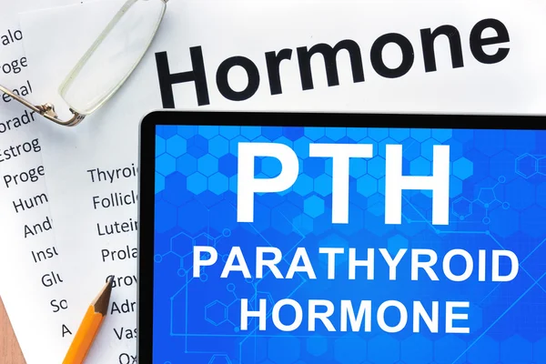 Papers with hormones list and tablet  with words  parathyroid hormone (PTH). — Stock Photo, Image