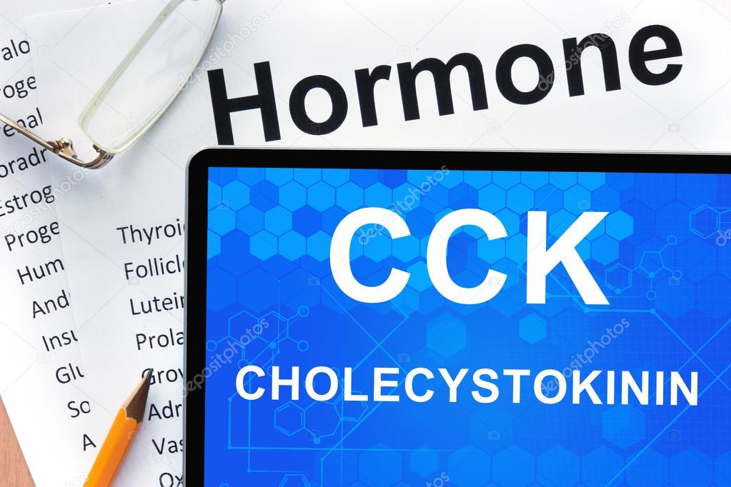 Papers with hormones list and tablet  with words  Cholecystokinin (CCK) .