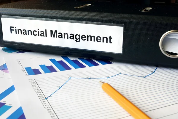 Graphs and file folder with label Financial Management. — Stock Photo, Image