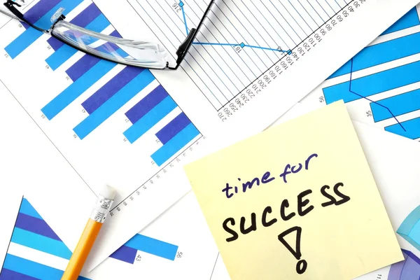 Papers with graphs and words time for success. — Stock Photo, Image