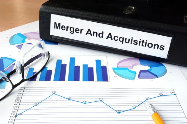 File folder with Merger and Acquisition and financial graphs. — Stock Photo, Image