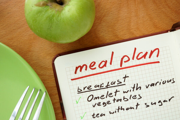 Notepad with words  meal plan with apple. Weight lose concept.