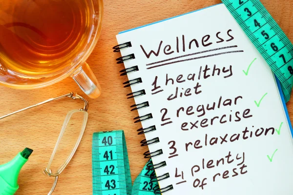 Notepad with  Wellness concept on a wooden board. — Stock Photo, Image