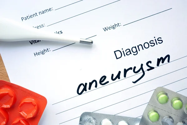 Diagnostic form with diagnosis Aneurysm and pills. — Stock Photo, Image
