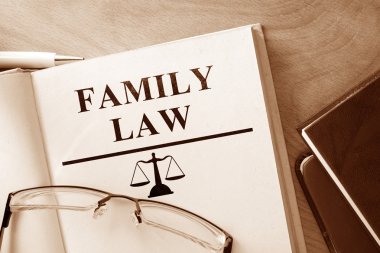 Book with words family law and glasses. clipart
