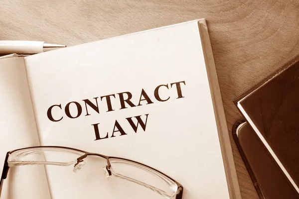 Book with words contract law and glasses. — Stock Photo, Image