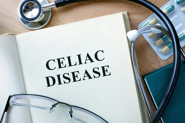 Celiac Disease concept. Book with stethoscope and pills. — Stock Photo, Image