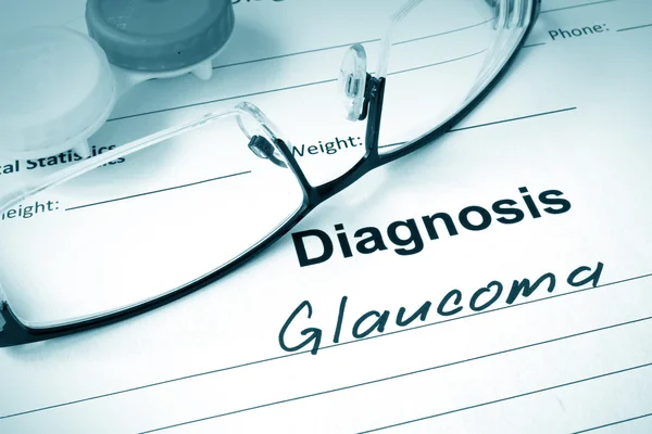 Diagnosis list with Glaucoma and glasses. — Stock Photo, Image