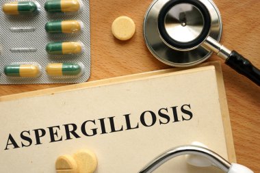 Word  Aspergillosis on a book and pills. clipart