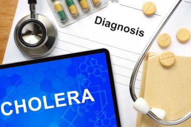 Word Cholera  on a book and pills. clipart