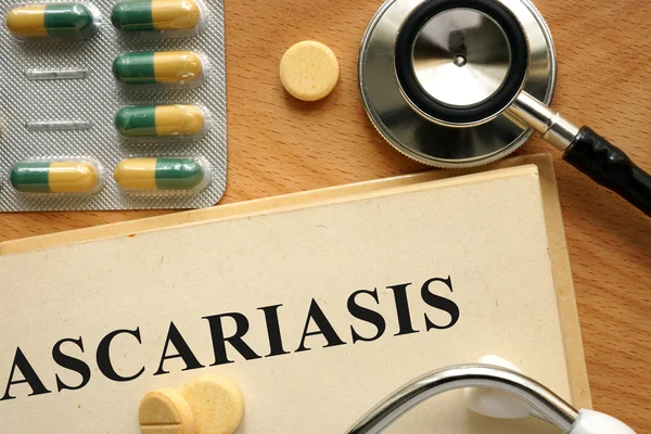 Word Ascariasis  on a book and pills. — Stock Photo, Image