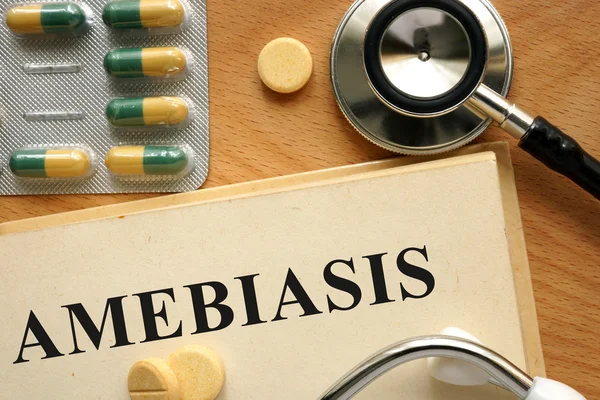 Word Amebiasis  on a book and pills. — Stock Photo, Image