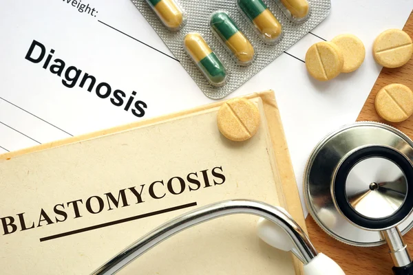 Word Blastomycosis  on a book and pills. — Stock Photo, Image