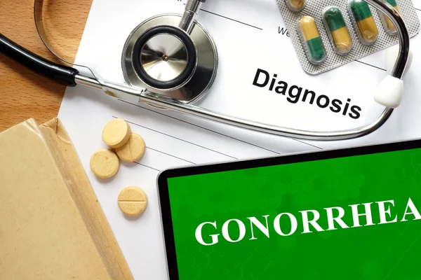 Wort Gonorrhoe auf einem Buch und Pillen. — Stockfoto