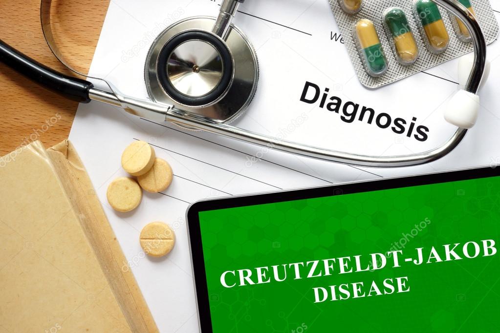 Word Creutzfeldt-Jakob disease  on a book and pills.