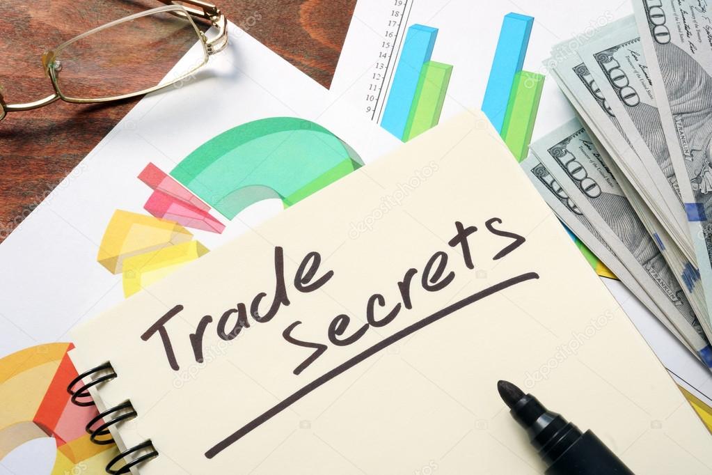 Trade Secrets  written on notebook with charts.