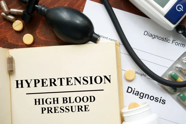 High blood pressure   hypertension  written on a book and diagnosis form. — Stock Photo, Image