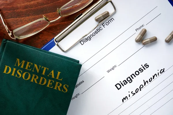 Misophonia concept. Diagnostic form and book on a table. — Stock Photo, Image