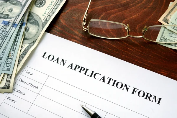 Loan application form on a wooden table. — Stock Photo, Image