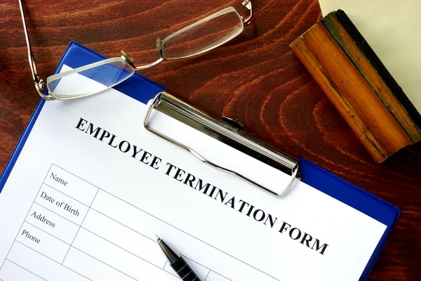 Employee termination form on a wooden table. — Stock Photo, Image