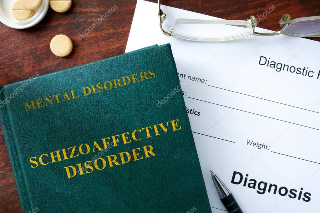 Schizoaffective disorder concept. Diagnostic form and book on a table.