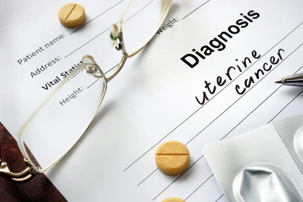 Diagnosis uterine cancer written in the diagnostic form and pills. — Stock Photo, Image